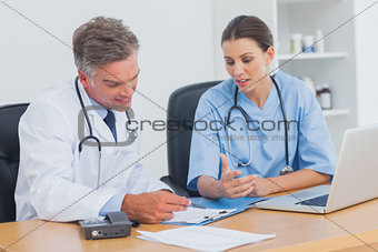 Two doctors working on an important folder