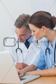 Two doctors working on a folded