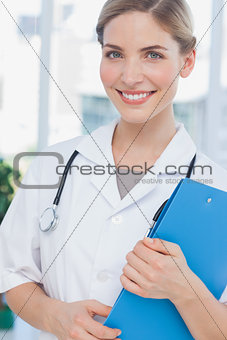 Radiant nurse holding a folder