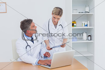 Nurse showing a folder to her colleague