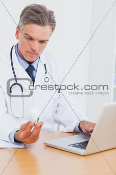 Doctor holding a bottle of pills