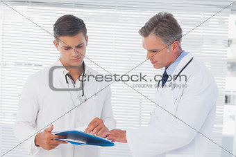 Doctors reading a folder