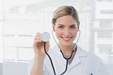 Attractive nurse showing her stethoscope