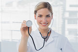 Pretty nurse showing her stethoscope