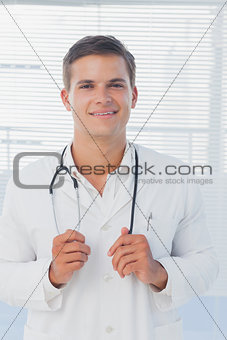 Young doctor holding his stethoscope