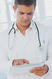 Attractive doctor using digital tablet