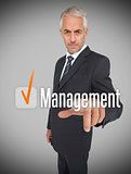 Businessman selecting the word management