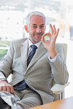 Happy businessman giving ok sign