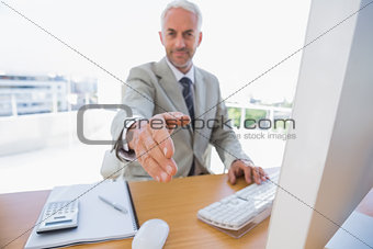 Happy businessman reaching arm out for handshake