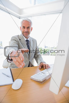 Happy businessman reaching hand out for handshake