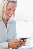 Businesswoman texting and smiling
