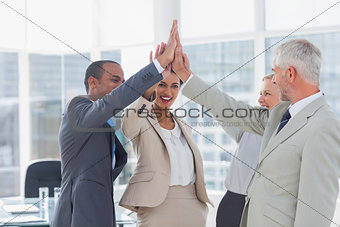 Happy business team high fiving