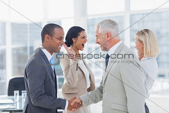 Succesful business team shaking hands and high fiving