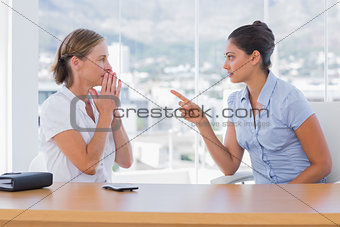 Businesswoman pointing to a colleague