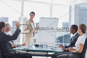 Colleagues asking a question to a businesswoman