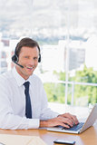 Smiling businessman wearing a headset