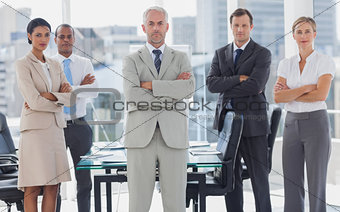 Serious team of business people posing together