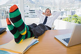 Businessman having a nap with feet on the desk