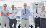 Team of business people standing with arms folded