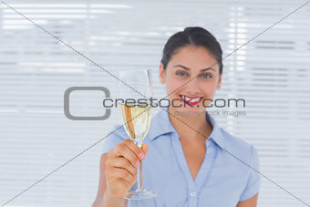 Businesswoman holding flute of champagne