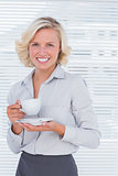 Blond businesswoman holding a cup