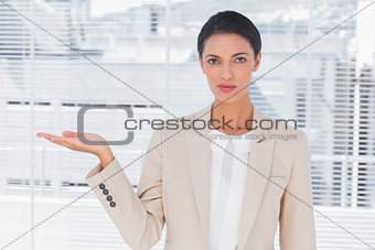 Pretty businesswoman opening her hand