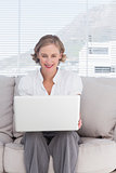 Portait of cheerful businesswoman with a laptop