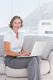 Attractive businesswoman using laptop