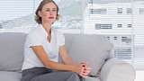 Serious businesswoman sitting on couch