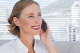 Portrait of businesswoman calling in a bright office
