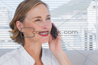 Portrait of businesswoman calling in a bright office