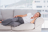 Businesswoman lying on couch