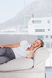 Relaxed businesswoman lying on couch