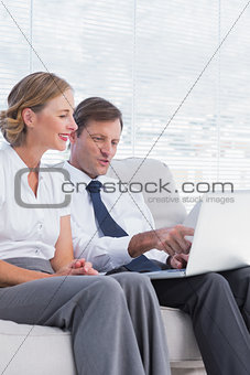 Businessman showing his laptop to a colleague