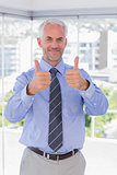 Businessman smiling with thumbs up