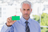 Businessman showing green business card