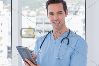 Male nurse holding a digital tablet