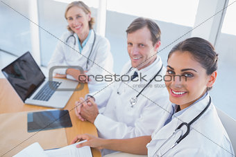 Overview of doctors looking at camera