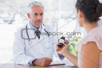 Patient holding jar of medicine
