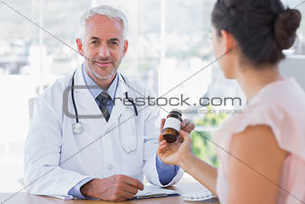 Patient holding a bottle of pills