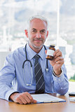Attractive doctor holding medicine jar