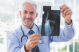 Smiling doctor holding a radiography