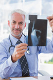 Attractive doctor showing a radiography