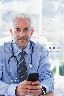 Doctor holding a mobile phone
