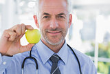 Doctor showing an apple