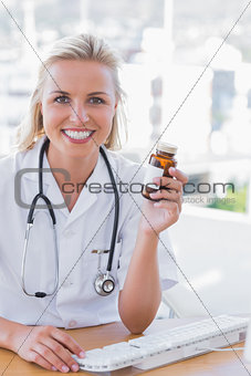 Smiling nurse holding a medicine jar