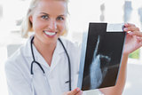 Cheerful nurse holding an x-ray