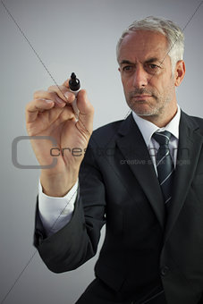 Attractive businessman holding a marker