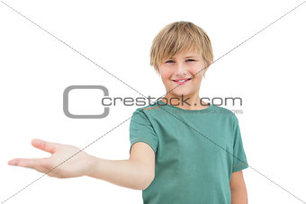 Smiling little boy holding something and looking at camera