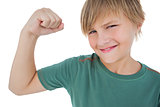 Little boy tensing arm muscle